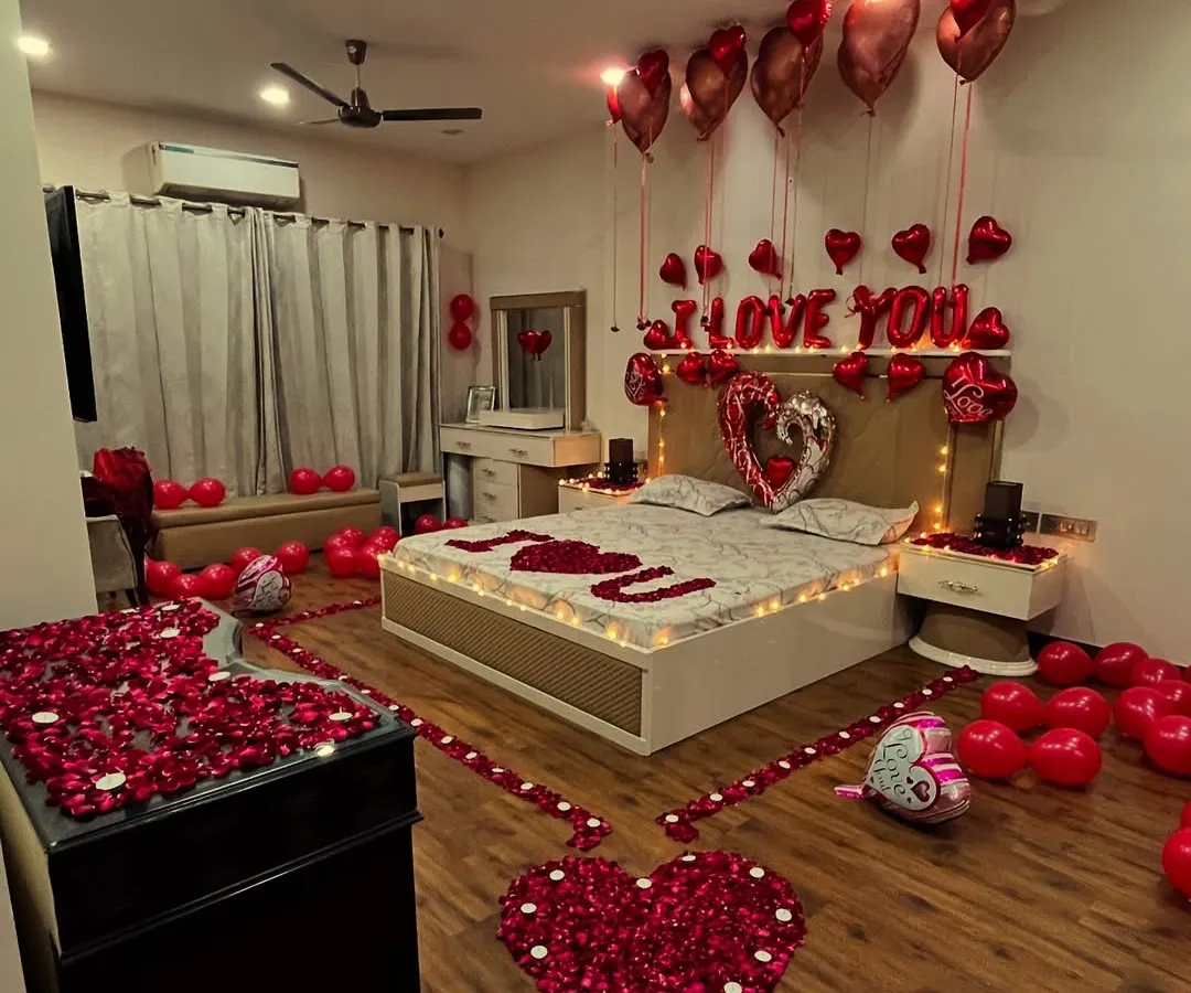 For the ultimate romantic gesture, we transform entire rooms into a haven of love. This surprise setup includes a pathway of rose petals, hundreds of red balloons, "I LOVE YOU" foil letters, and soft lighting to create an unforgettable anniversary or proposal experience.