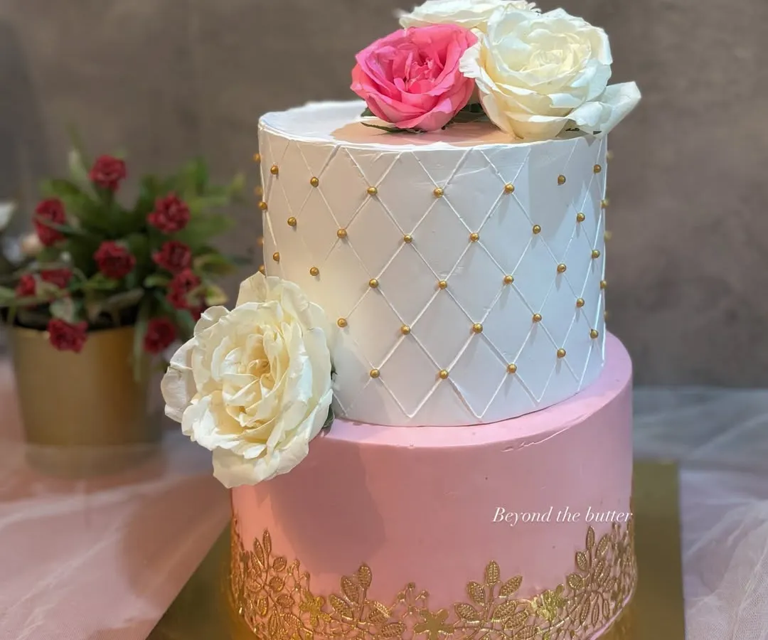 I believe every wedding deserves a stunning cake. This two-tier beauty features a classic white quilted design with gold pearls, a delicate gold lace pattern on the pink bottom tier, and is finished with beautiful fresh roses. It’s a timeless choice for a Nikkah or engagement.