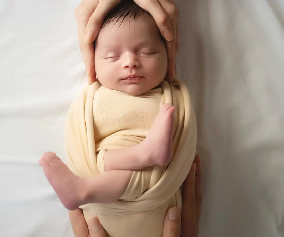 Safely held in your hands, so tiny and new. I focus on creating serene, artistic portraits that celebrate the profound love surrounding your newborn. This is a memory of their first days, preserved forever.