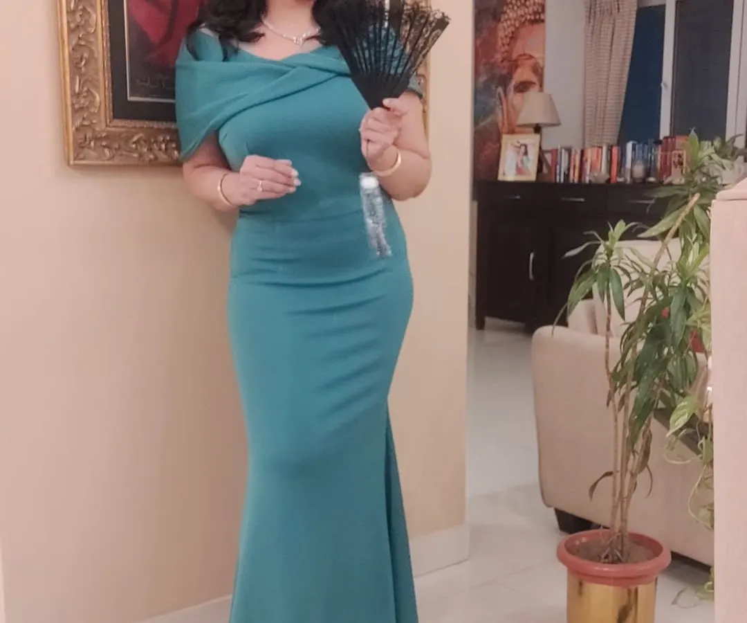 When the party has a theme like 'Bridgerton', I love the challenge of creating a look that is both fitting and personal. This teal evening gown, paired with a precious diamond set from my mother, was my take on the theme for a New Year's Eve party. I can help you find that perfect statement outfit for any special event.