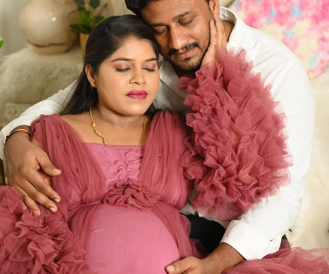 Capturing the quiet, tender moments between a couple is so special. This indoor portrait focuses on their connection and the shared joy of waiting for their little one.