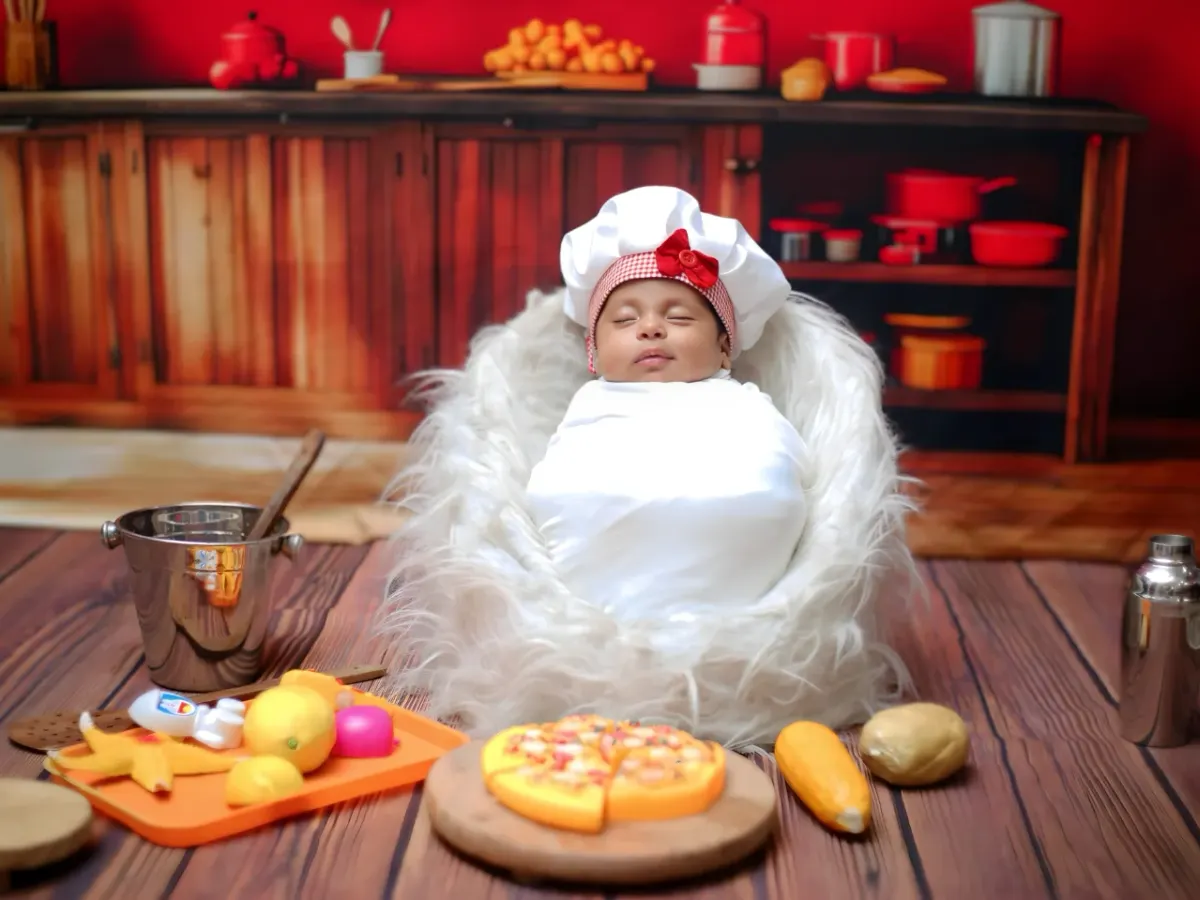 Welcome the little chef! This is an example of one of my creative newborn themes, where I bring a complete, safe, and adorable kitchen setup right to your home. It's a playful way to capture your newborn's first professional photos.