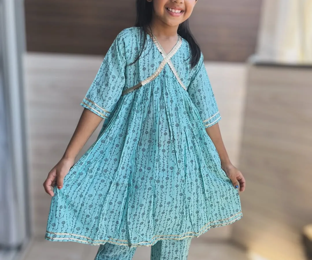 I believe traditional wear should be full of grace, not restrictions. This light and airy blue Angarkha set is made from pure cotton, allowing for endless twirls and happy giggles. The delicate gold detailing adds just the right amount of festive sparkle.