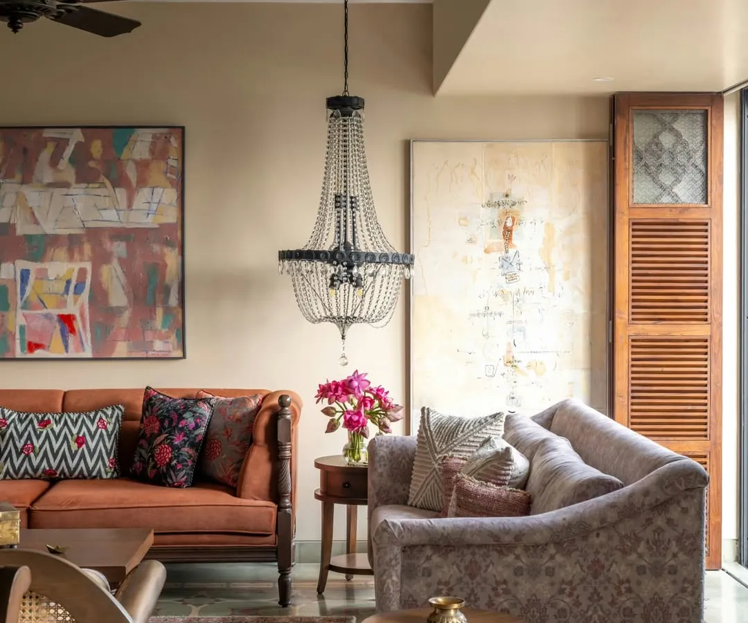 In this Calcutta home, the living room needed to hold the energy of a full-hearted joint family. We mixed earthy tones, worn-in woods, and vintage finds to create a space that feels generous and grounded. The elegant chandelier adds a touch of old-world charm, balancing nostalgia with a modern way of living.