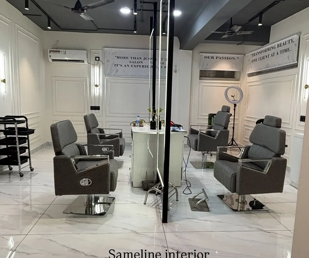 A look at the main cutting section of our East Patel Nagar salon project. We designed this space with custom-lit mirrors, clean marble-finish flooring, and elegant wall mouldings to create a high-end, professional atmosphere for clients.