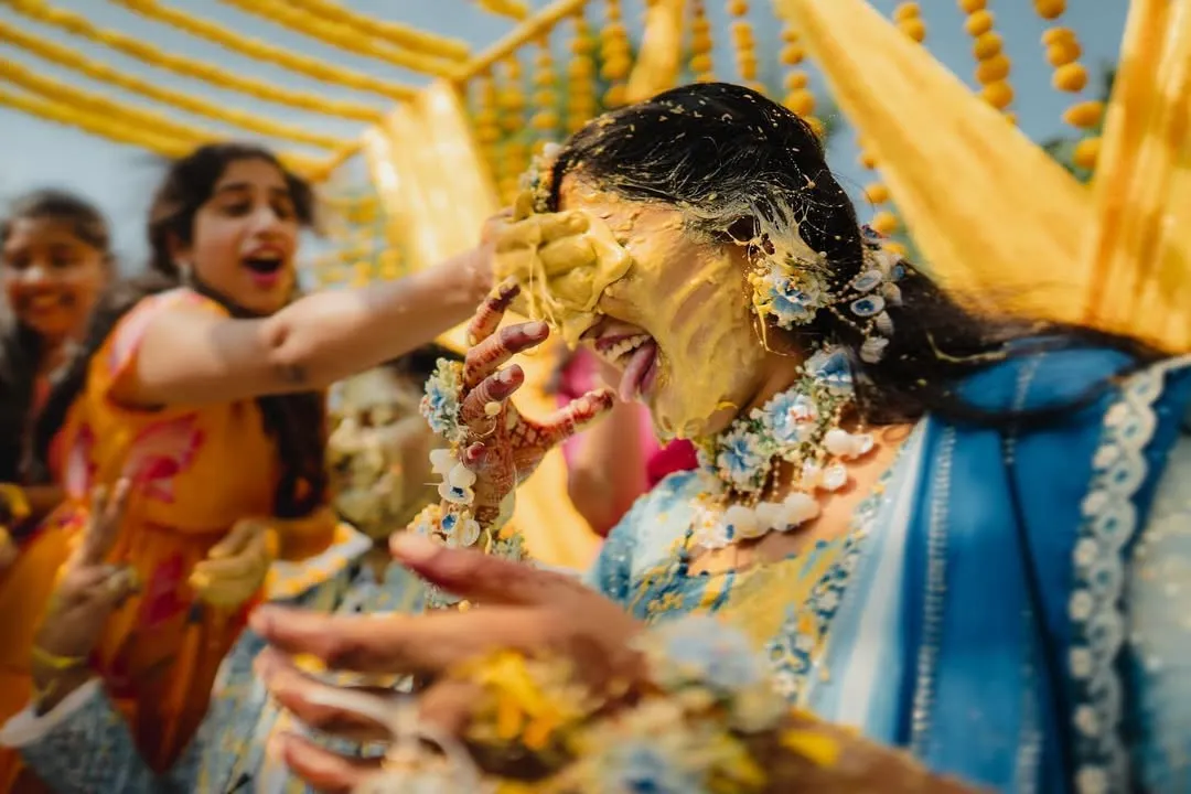 The pure, uninhibited joy of a Haldi ceremony. We live for these candid moments, getting right into the action to capture the real laughter and playful chaos. This shot is all about raw energy and celebration.