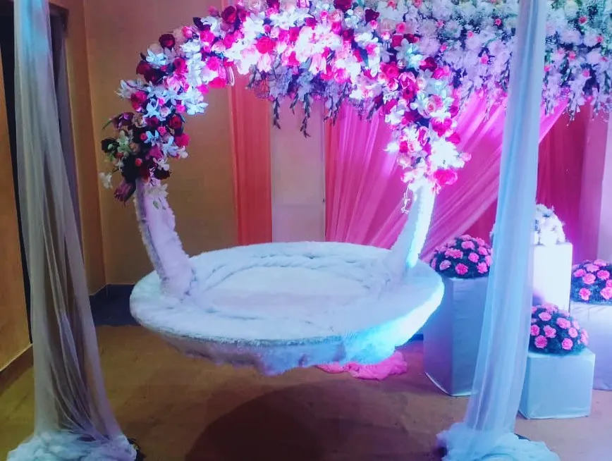 For a beautiful naming ceremony, we created this custom floral swing or 'jhula'. The design combines a dense arch of pink and white flowers with soft, elegant draping to create a magical focal point.