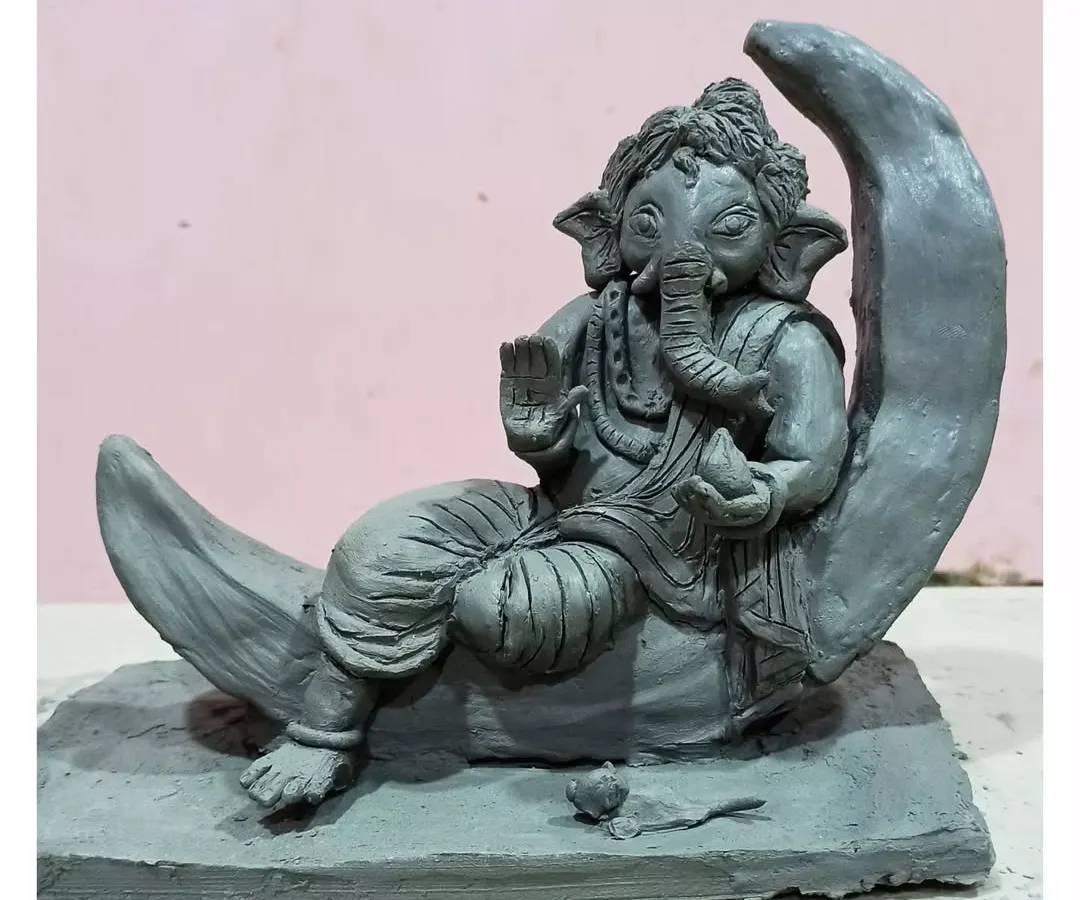 This serene Ganesha rests on a crescent moon, a design I sculpted for the first time based on a client's request. It's a completely handmade Shadu clay idol, perfect for an eco-friendly visarjan.
