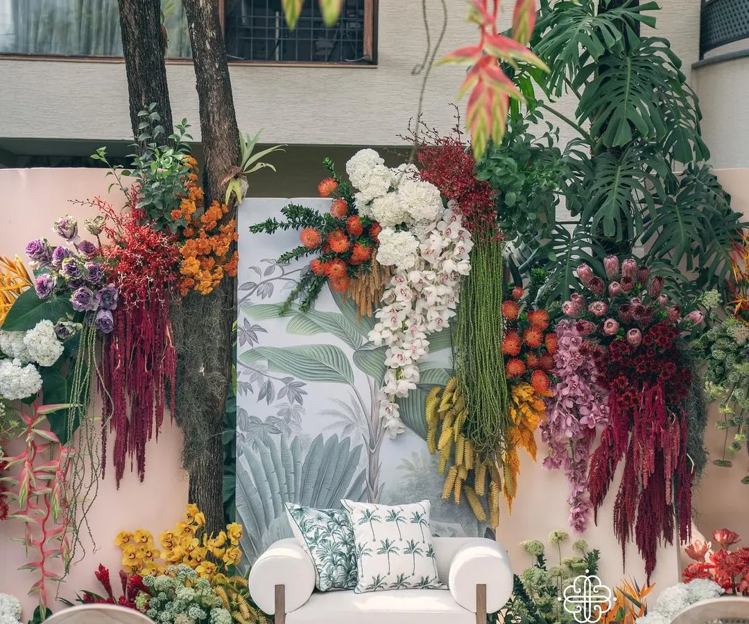 The 'Garden of Gaia' theme brought to life for a vibrant baby shower. This lush floral backdrop, bursting with tropical blooms and rich textures, transforms a backyard into a sacred, celebratory space for the mom-to-be.