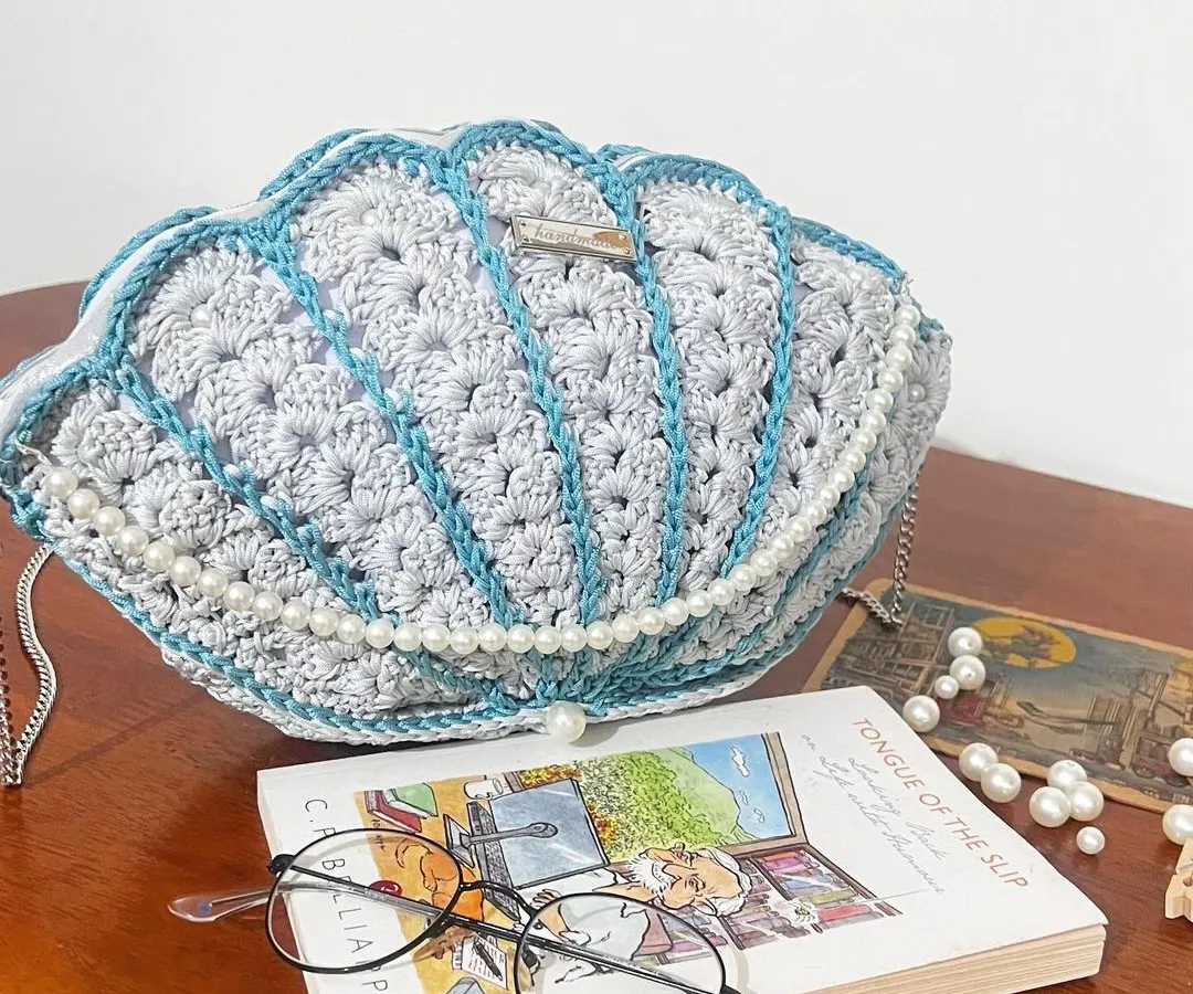 Bringing beachy vibes to you with this custom Seashell Bag. I crafted this piece with delicate pearl details and a silver chain strap, making it a truly unique accessory. It’s perfect for when you want to carry a little bit of the ocean with you.