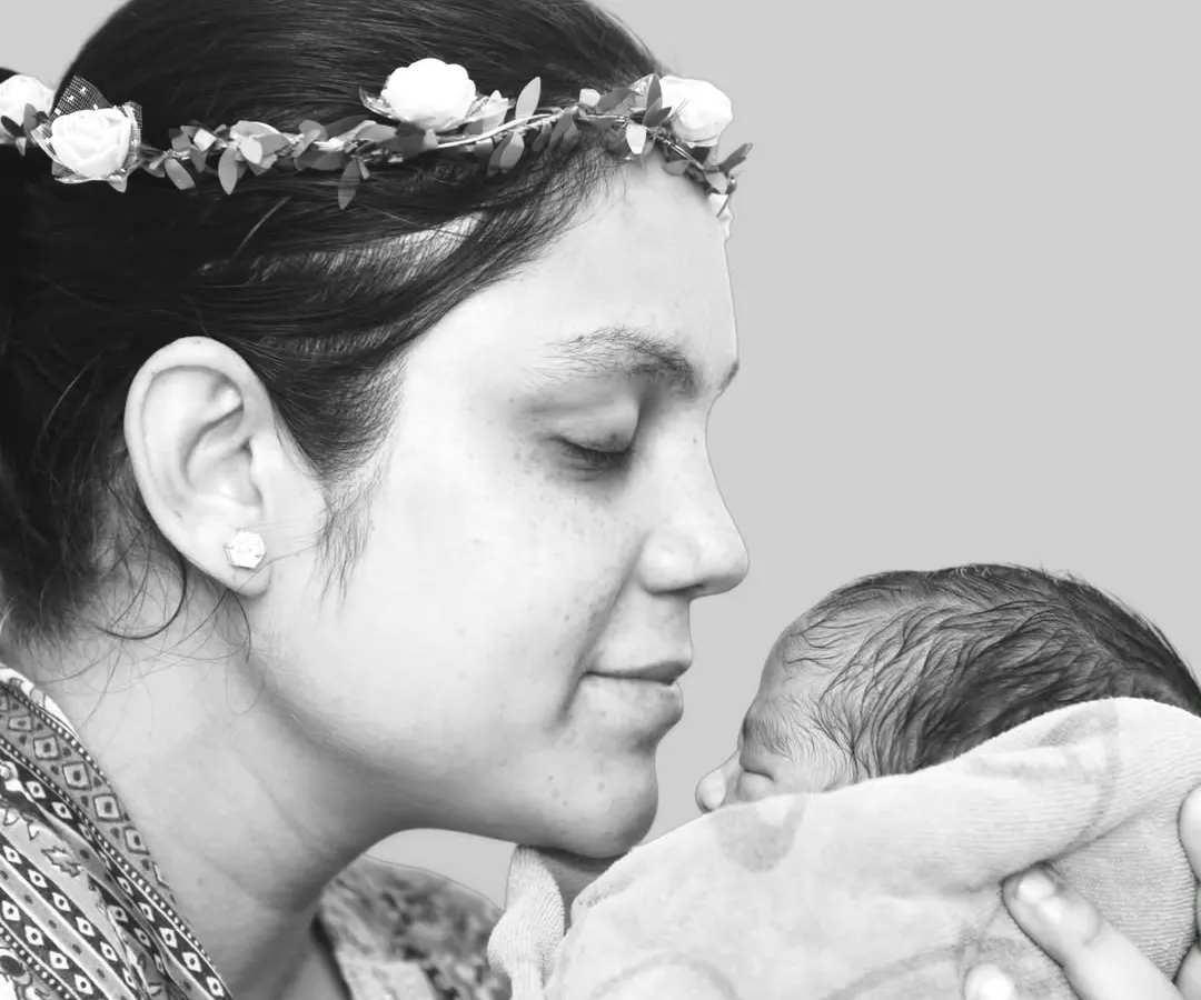 There is nothing more powerful than a mother's love. This black and white portrait focuses on the quiet, tender connection between a new mother and her baby, a timeless memory captured forever.