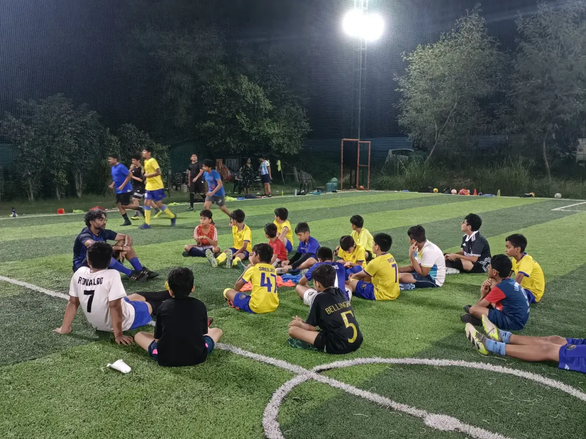 The game isn't just won with your feet, but with your mind. Here, our AIFF licensed coach breaks down tactics with the team under the lights, turning players into thinkers.
