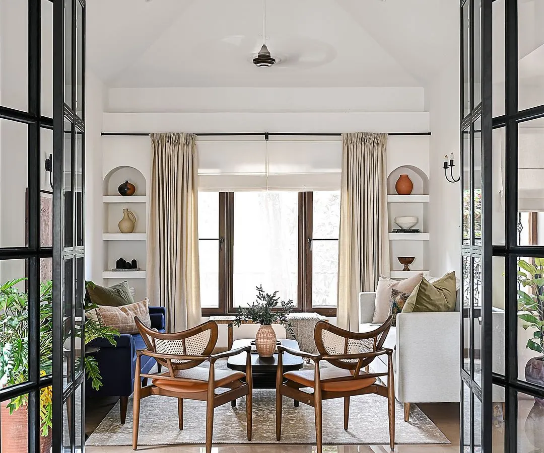 I love creating dramatic moments that redefine a space. Here, custom black iron and glass doors were designed to separate two living areas, adding architectural interest and a sense of grandeur while still allowing light to flow through. It’s a perfect example of how a single feature can transform the entire feel of a home.