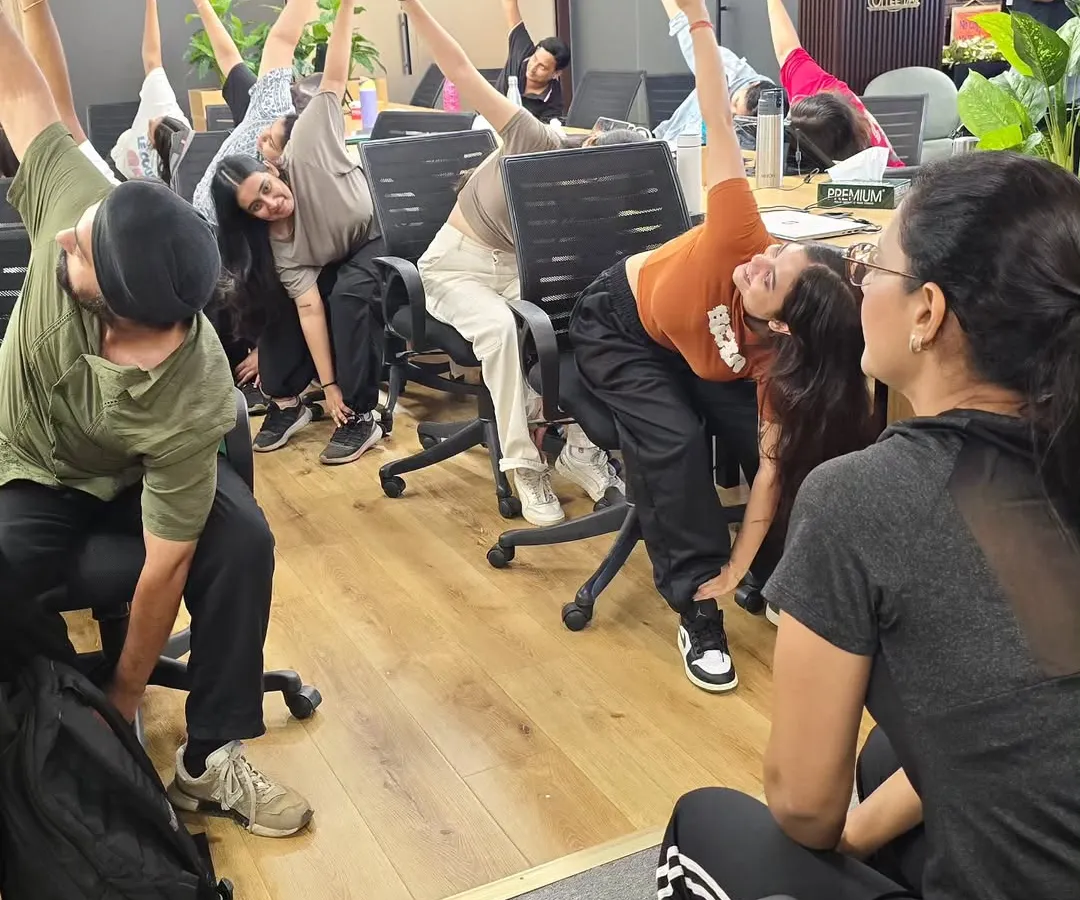 To combat the stiffness that comes from hours of sitting, I lead practical chair yoga sessions. These stretches are designed to be done at a desk, targeting common issues like backaches and tight shoulders.