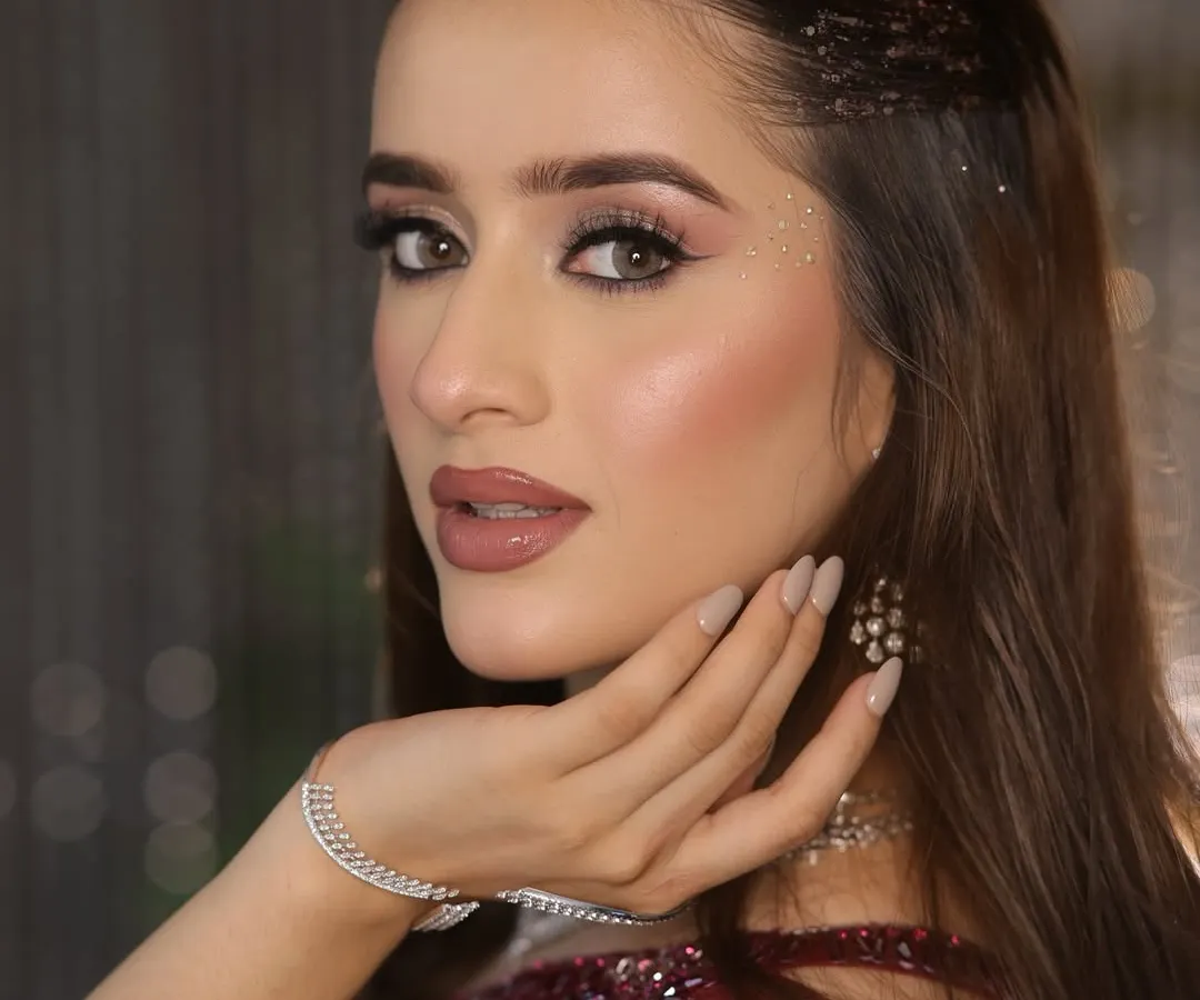 A close-up of a glamorous cocktail look. I focused on creating luminous, dewy skin, soft smokey eyes with a hint of sparkle, and a perfectly defined nude lip to achieve that sophisticated, camera-ready finish.