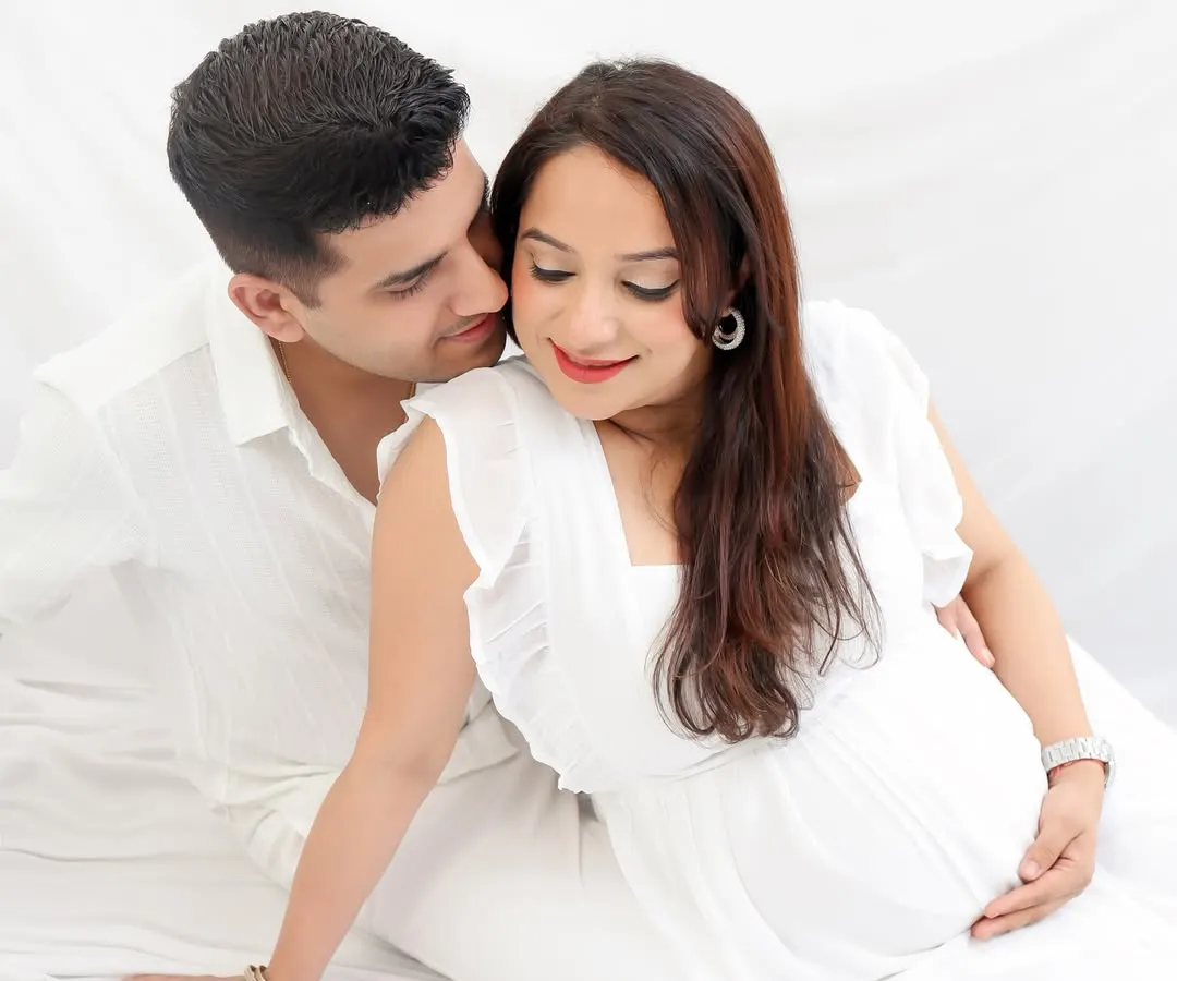 The beautiful beginning. This classic, all-white studio maternity session focuses on the pure love and quiet excitement between parents-to-be. A simple and timeless way to remember this special journey.