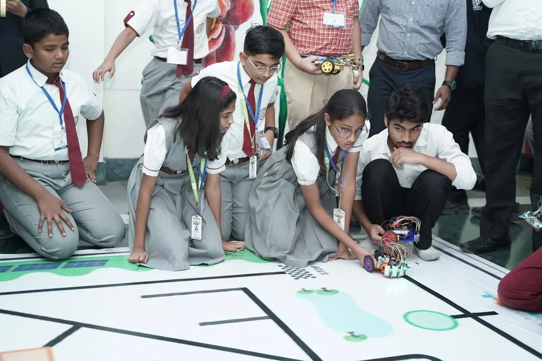 A student from our program focuses intently during the Robotics Championship held at IIT Delhi. We provide platforms for young innovators to test their skills on a national stage.