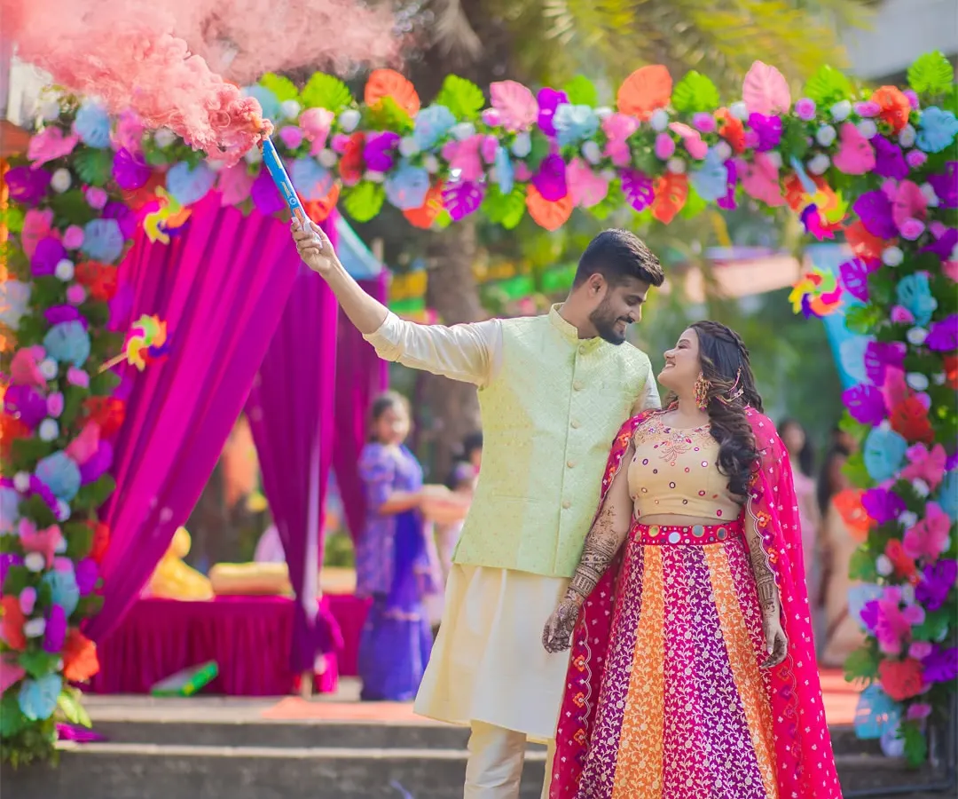For Prachi and Sandeep's vibrant Mehendi, we used a smoke bomb to create this energetic and colorful shot. It's all about capturing the fun and excitement of your pre-wedding celebrations in a dynamic way.