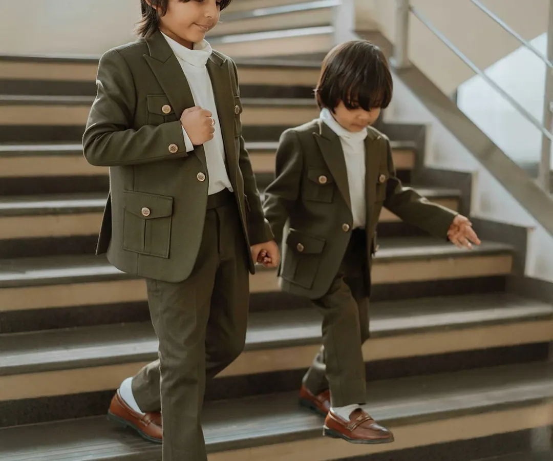 The bond between brothers is special, and we love creating outfits to match. Here, two brothers wear our custom-designed olive green shacket sets, featuring functional pockets and a comfortable fit, perfect for making memories together.