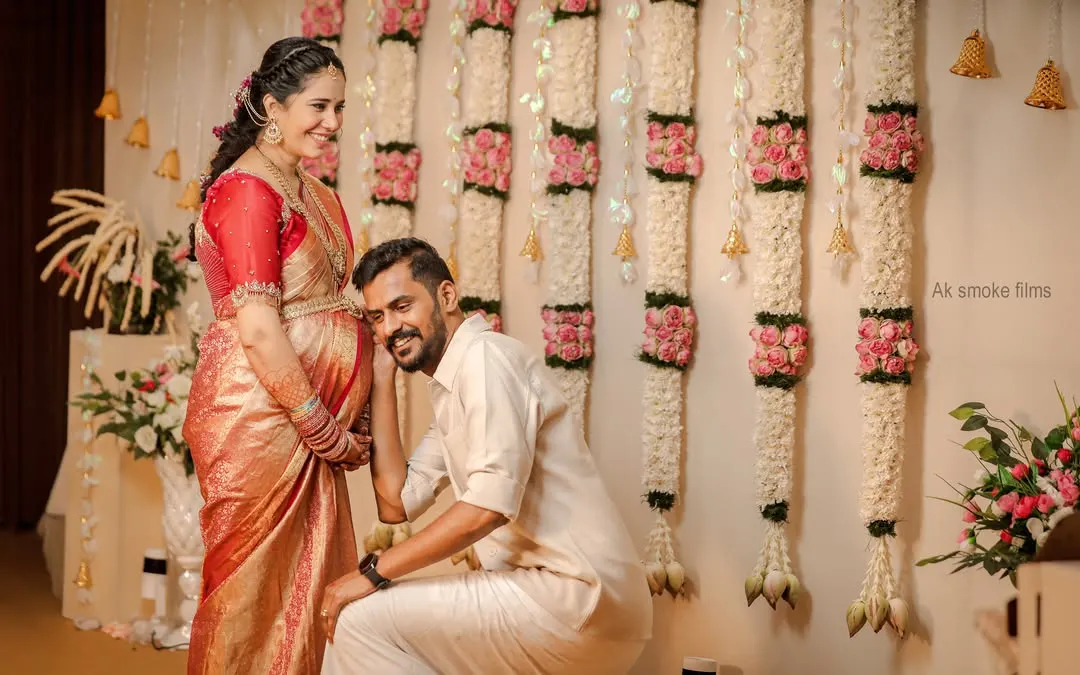 A classic, heartwarming moment between expecting parents during their traditional baby shower ceremony. We love capturing these sweet, unscripted interactions, like the dad-to-be listening to his baby against the backdrop of a lovely floral wall.