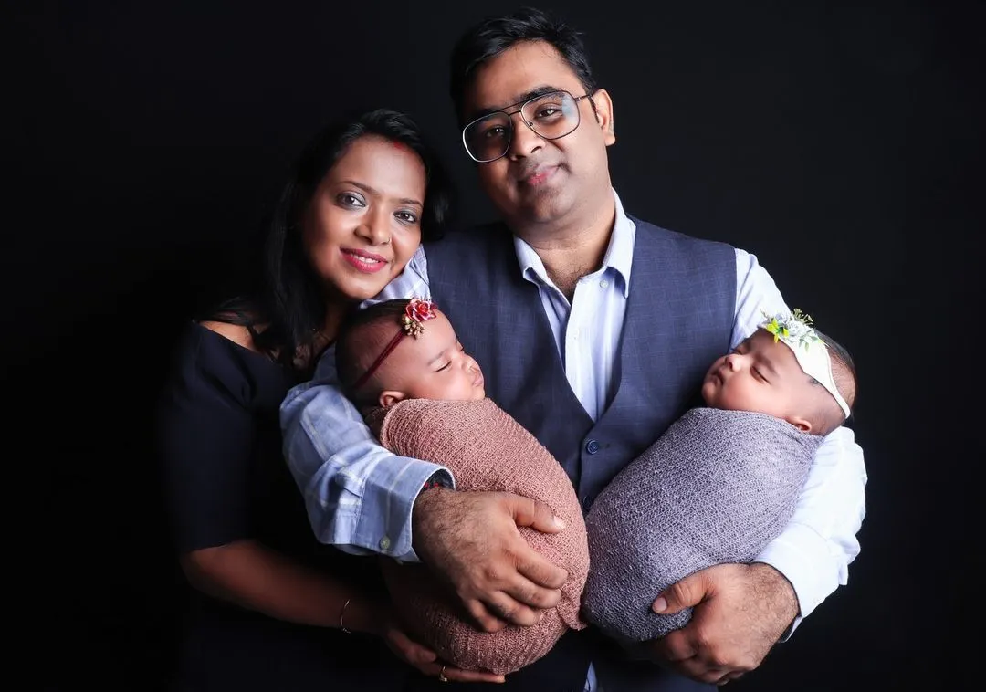Capturing double the joy with a beautiful studio portrait of parents holding their newborn twins. I have experience posing and photographing twins to create cherished family keepsakes.