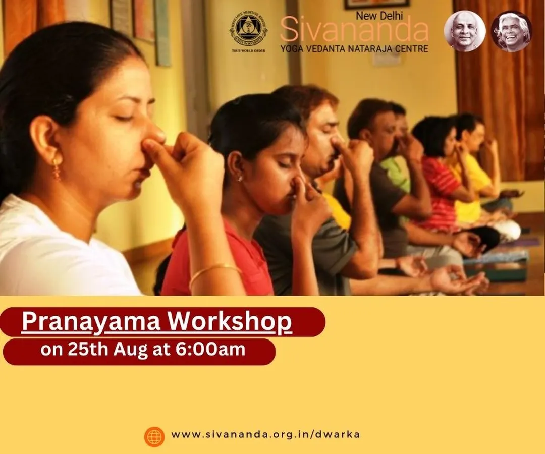 Students in a Pranayama workshop practicing Anulom Vilom, or alternate nostril breathing. This fundamental technique is taught to help balance the body's energies and calm the nervous system.