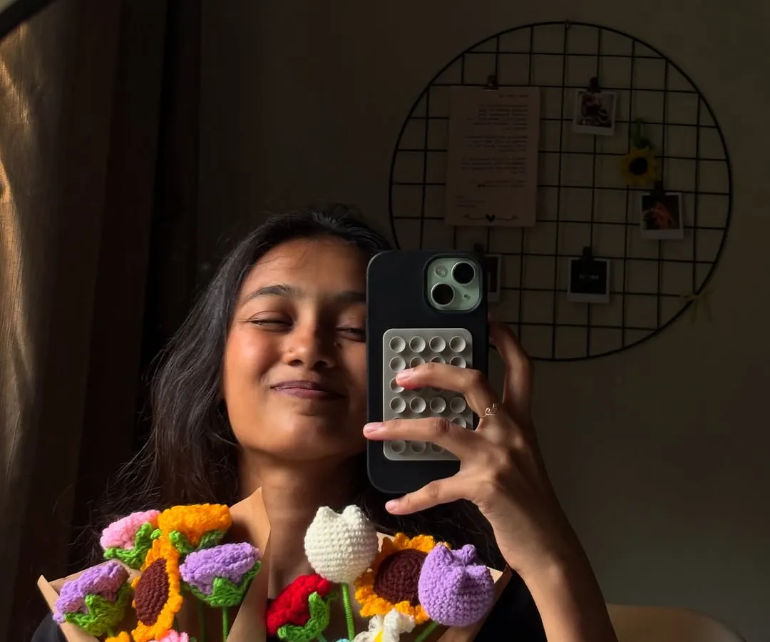This is me in my natural habitat, surrounded by yarn and chaos. I whipped up these colorful crochet flower bouquets in just 24 hours for a rush order. Each bouquet is unique, featuring a mix of flowers like sunflowers, tulips, and roses that will never wilt. 💐