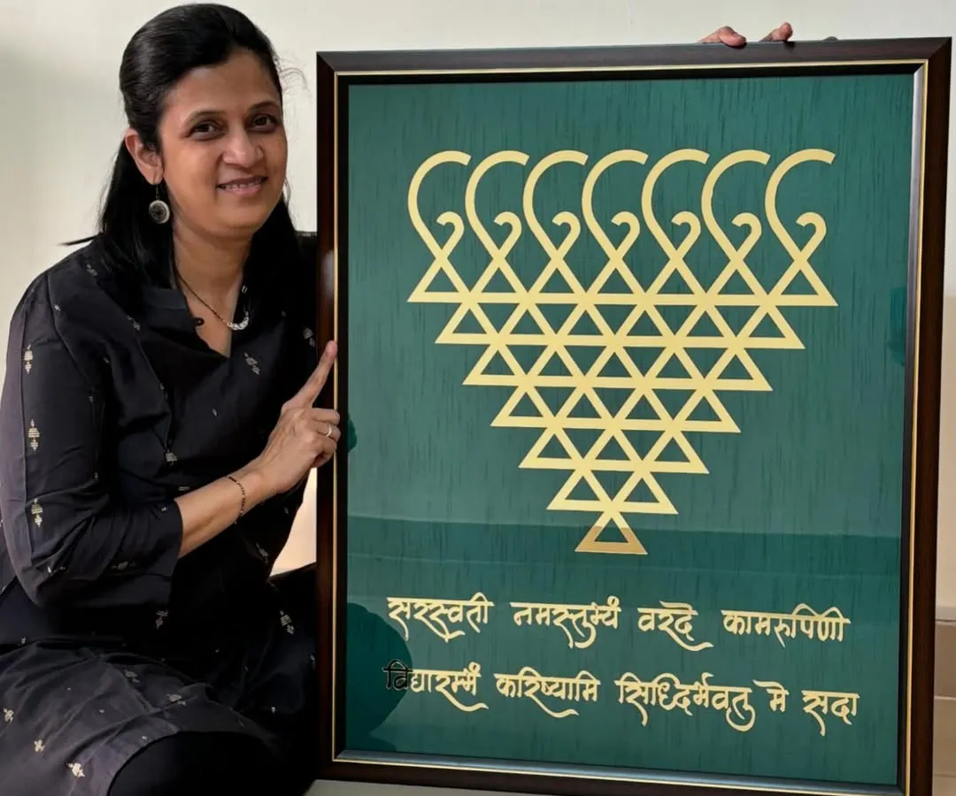 Here I am with a large, custom-made Saraswati frame. This piece, featuring the sacred yantra and shloka, was created to bring blessings of knowledge and peace to a client's home. I can customize the size and colors to perfectly match your space.