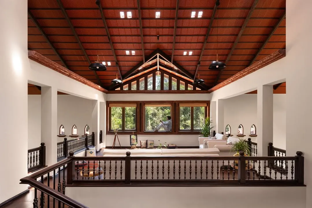 This mezzanine lounge is a sanctuary in the sky, where architecture opens its arms to the landscape. Crowned by a soaring terracotta tiled roof with glass skylights, the space blurs the line between indoors and nature, inviting the forest canopy into the room.