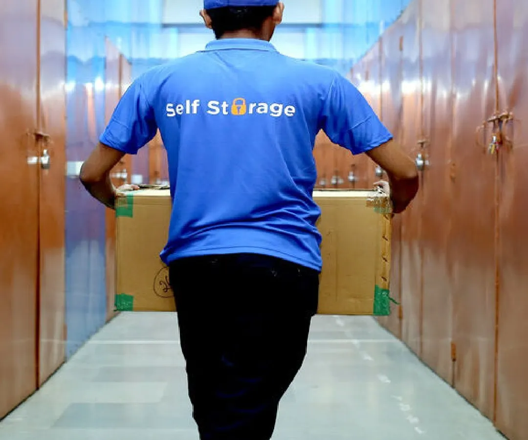 Our professional team is always on hand to assist you. Here you can see one of our staff members moving business goods into a secure unit, showcasing our commitment to providing a seamless and supportive storage experience.