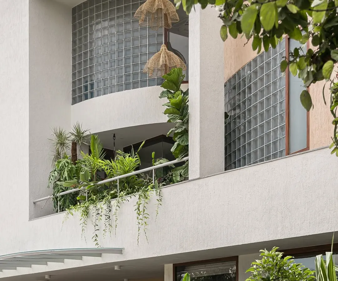 Here, the home's facade becomes a living garden. We integrated deep planters into the balconies, allowing vines and tropical foliage to cascade down, softening the structure and creating a vibrant, green exterior.