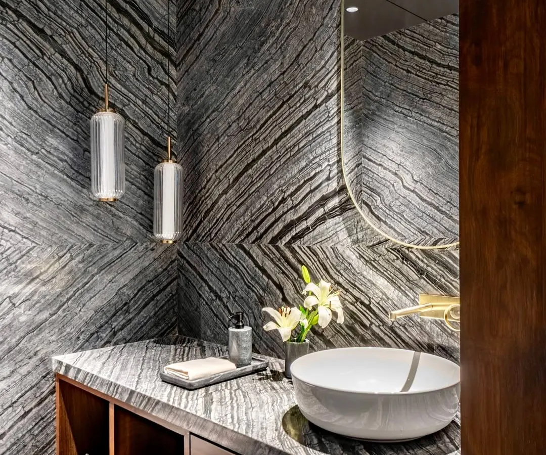 Materiality is at the core of our practice. In this powder room for the Parishram residence, we used book-matched slabs of dramatic, locally sourced granite to create a powerful visual statement, turning a functional space into a work of art.