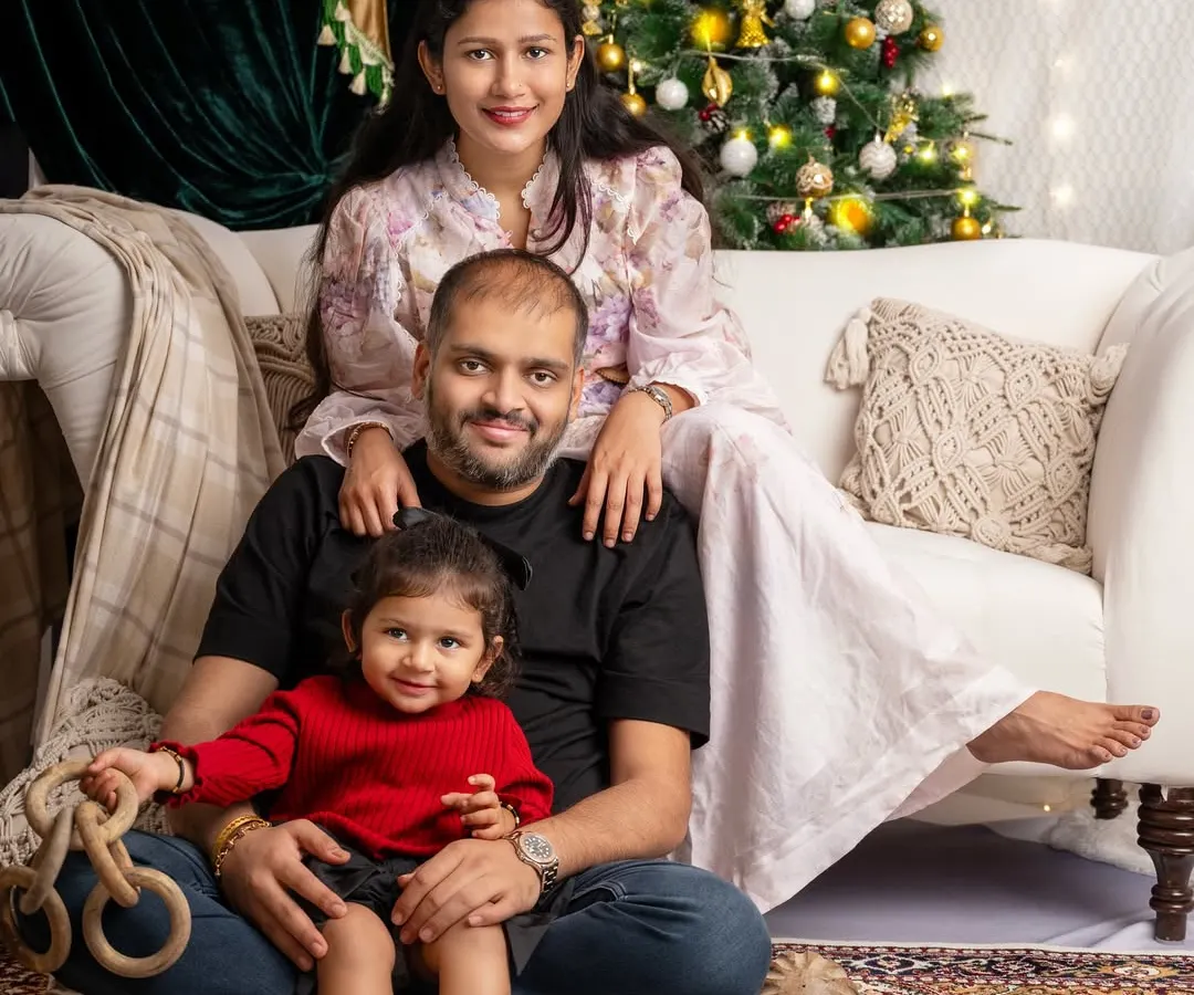 A perfect family moment, wrapped in the warm glow of Christmas lights. These are the pictures that become cherished holiday cards and timeless memories.