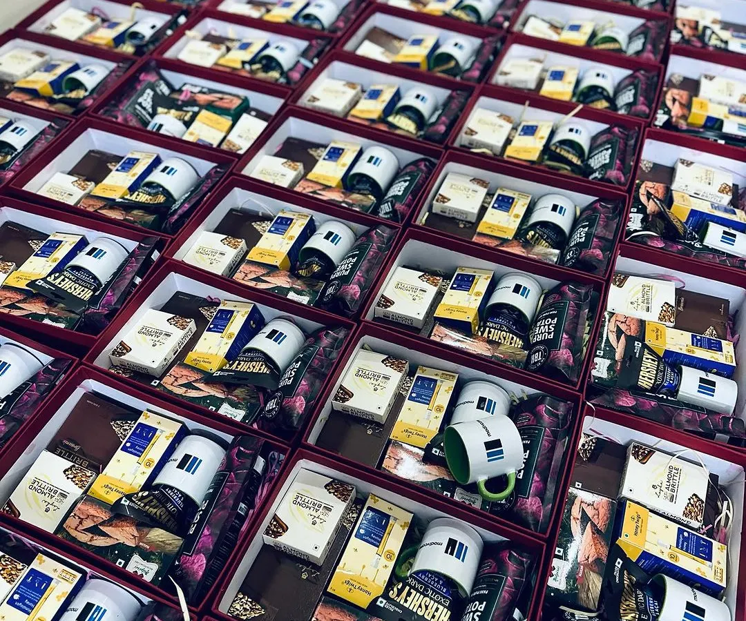 We excel at handling large corporate orders, like this one for Modiwave. Each gift box is carefully packed with branded mugs and a selection of gourmet treats, ensuring a consistent and high-quality brand experience for every recipient.