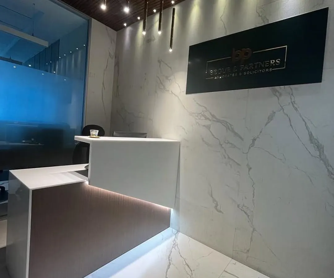 We designed the reception for an advocate’s office at BKC One to be a statement of modern professionalism. The space features dramatic white marble walls, a custom multi-level desk with integrated lighting, and sleek pendant lights that create a powerful first impression.