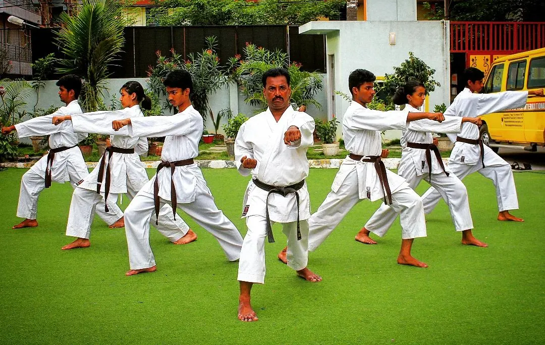 As a Renshi, I lead every class personally, ensuring each student masters the fundamental stances and punches. Here, we practice the zenkutsu-dachi stance, building a strong foundation together.