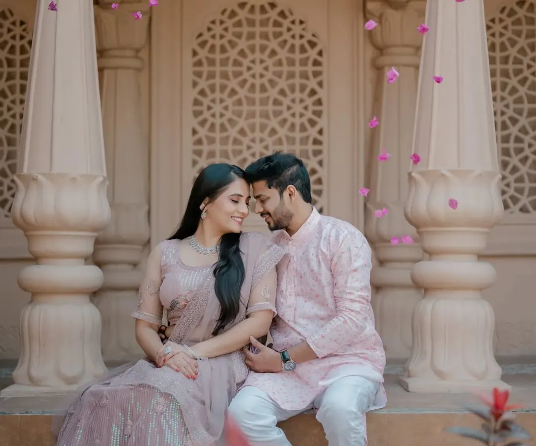 I love creating grand, fairytale-like images. Here, we used the stunning architecture to frame the couple, with flower petals adding a touch of magic. This is for couples who dream of a pre-wedding shoot that feels both royal and romantic.