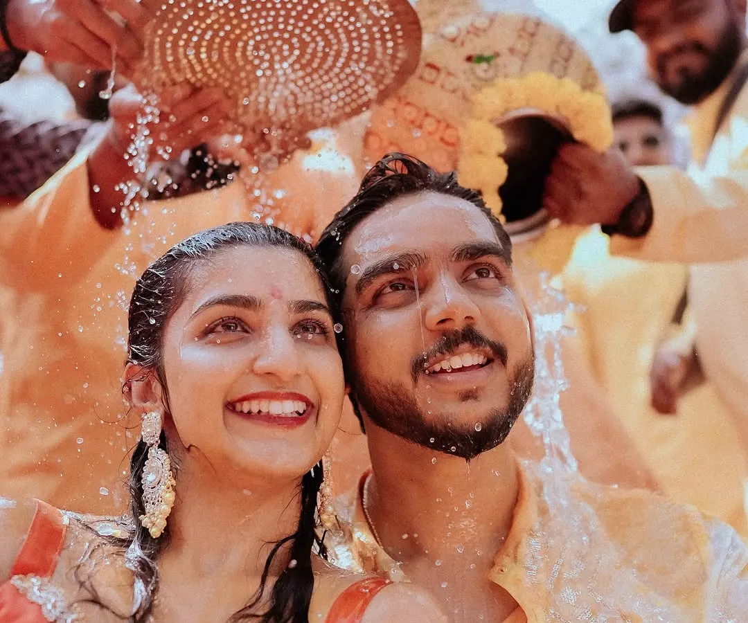 The pure, unscripted joy of a Haldi ceremony. I focus on capturing these genuine smiles and laughter as family and friends shower the couple with blessings and turmeric-infused water.