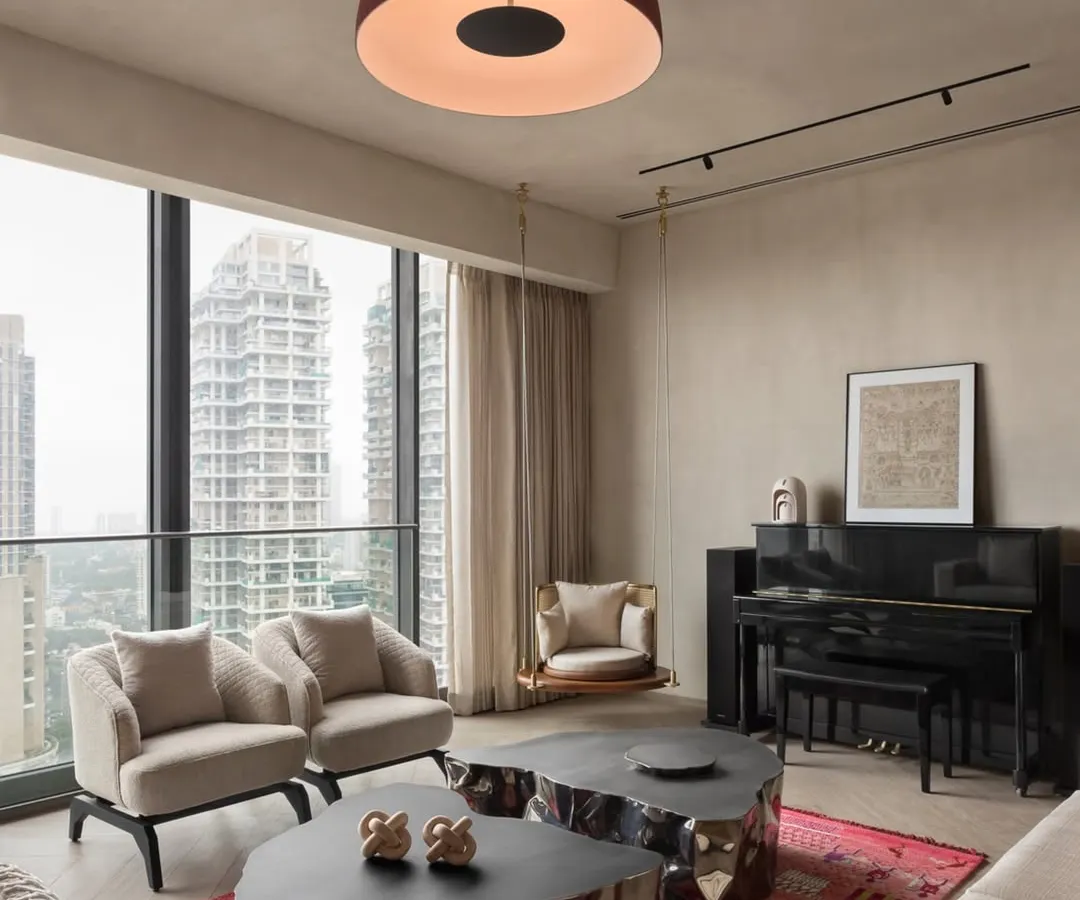 In this urban apartment, we balanced a neutral, textured palette with bold, sculptural furniture and vibrant art. The design creates a sophisticated living area that feels both dynamic and inviting, with large windows framing the city skyline.