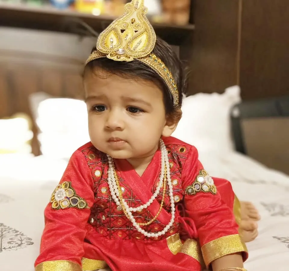 Designing for my own son is one of my greatest blessings. For him, I created this vibrant red Angrakha-style kurta with delicate embroidery and a matching golden crown, perfect for a festive celebration. It's a joy to craft comfortable and unique traditional wear for the littlest members of the family.
