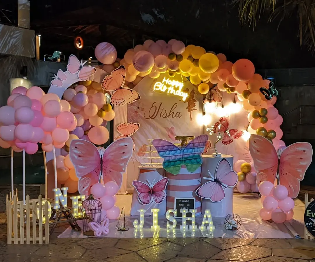 This enchanting butterfly theme was perfect for a first birthday party. We used a soft pastel balloon arch, large butterfly cutouts, and marquee lights with the birthday girl's name to create a whimsical garden feel.