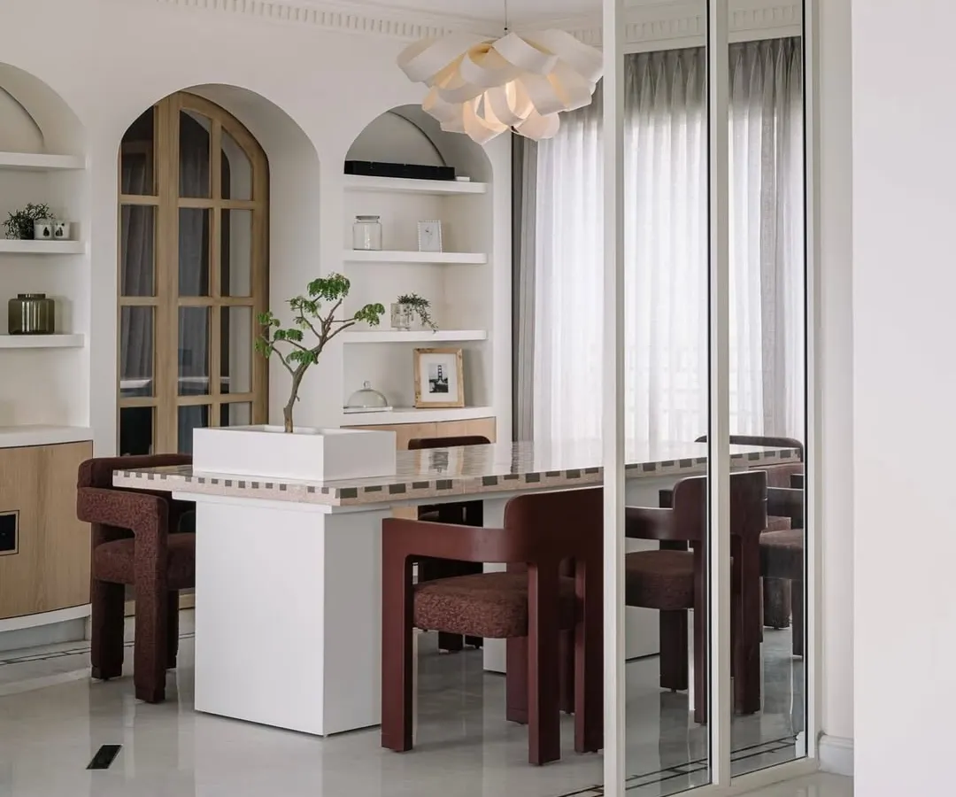Welcome to Eden House, a 10,000-square-foot penthouse in Bengaluru designed to be a whimsical celebration of life. In this dining area, we played with form and light, creating a space that feels both grand and intimate, centered around a bespoke dining table that invites connection and conversation.
