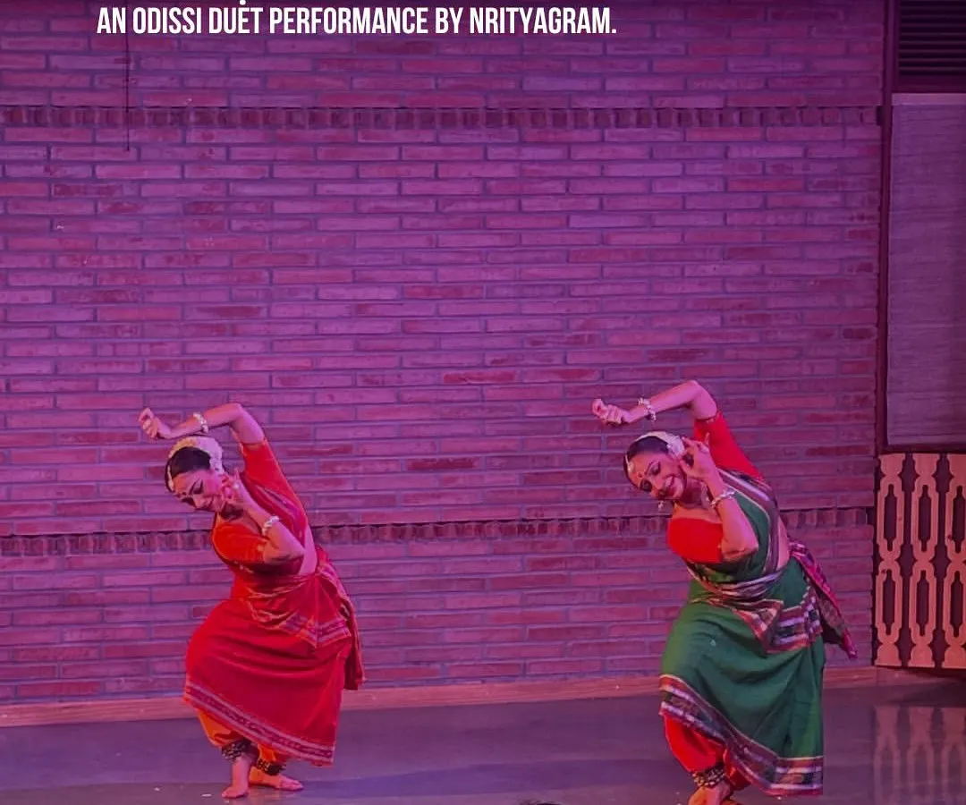 The grace of Odissi fills our stage. Here, dancers from the renowned Nrityagram perform 'Aṅgahāraḥ', a duet that showcases perfect synchronization and emotive storytelling, bringing ancient traditions to a contemporary audience in a close-up, personal setting.
