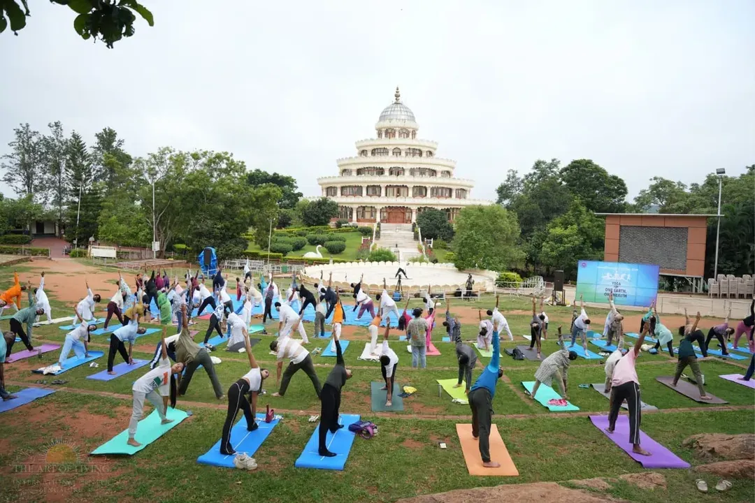 Experience the collective energy of practicing yoga together at our international center in Bengaluru. This image from an International Day of Yoga celebration shows hundreds of people finding harmony in body and mind against the backdrop of our iconic Vishalakshi Mantap.