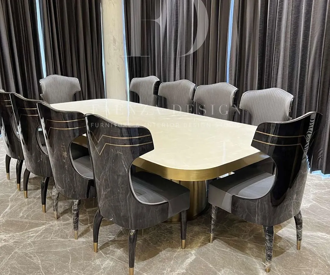 We believe the dining room is for making memories. This grand 10-seater dining set, featuring a polished onyx tabletop and uniquely designed chairs with gold accents, is crafted to be the centerpiece of your home's hospitality.