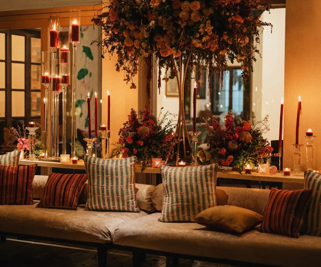 I believe the right ambiance is crucial to the dining experience. Here, I used towering floral arrangements, candelabras, and warm, layered lighting to create an intimate and luxurious setting for an evening event.