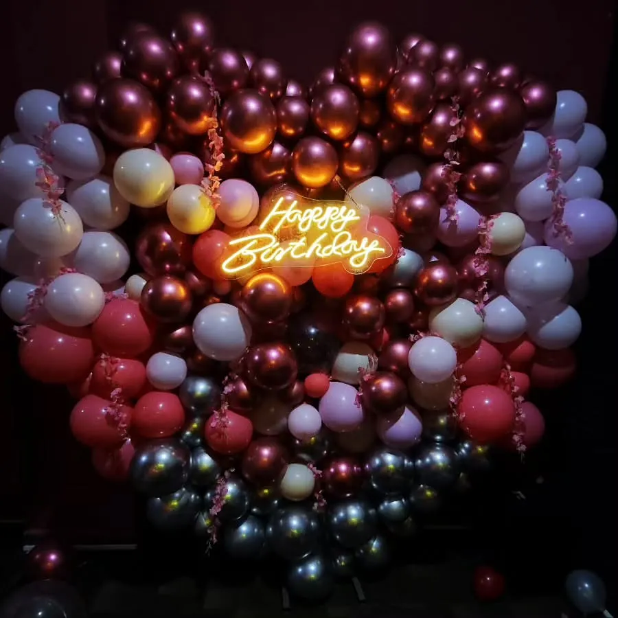 I love creating bold statements like this massive heart-shaped balloon wall. Paired with a glowing 'Happy Birthday' neon sign, this setup in rich metallic tones is guaranteed to be the star of your celebration and your photos.