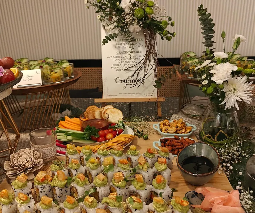 Our Gold Dragon Sushi rolls are a testament to our love for Asian cuisine. This beautifully arranged platter, complete with fresh flowers and elegant branding, showcases how we transform event catering into a sophisticated culinary experience.