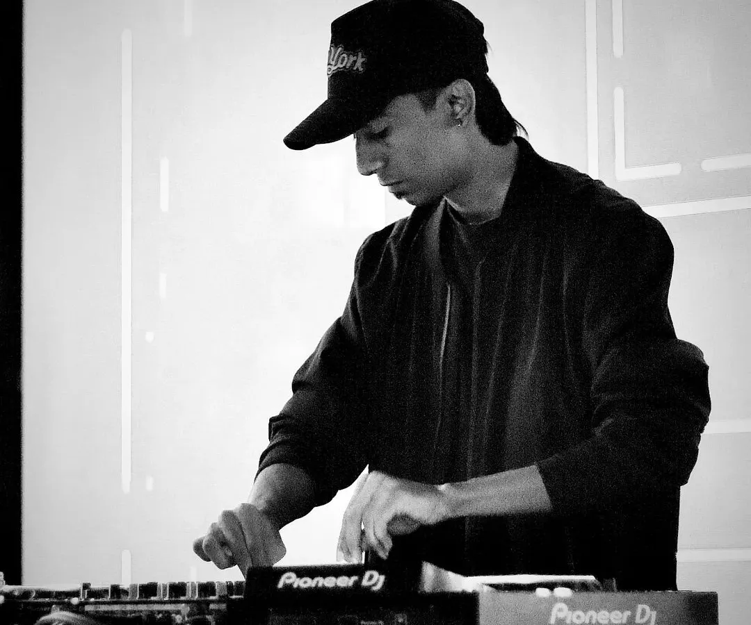 In the zone, finding the perfect beat. This is me at the console, completely focused on mixing tracks and creating a seamless flow of music. I use professional Pioneer DJ equipment to ensure the sound quality for your virtual event is top-notch.