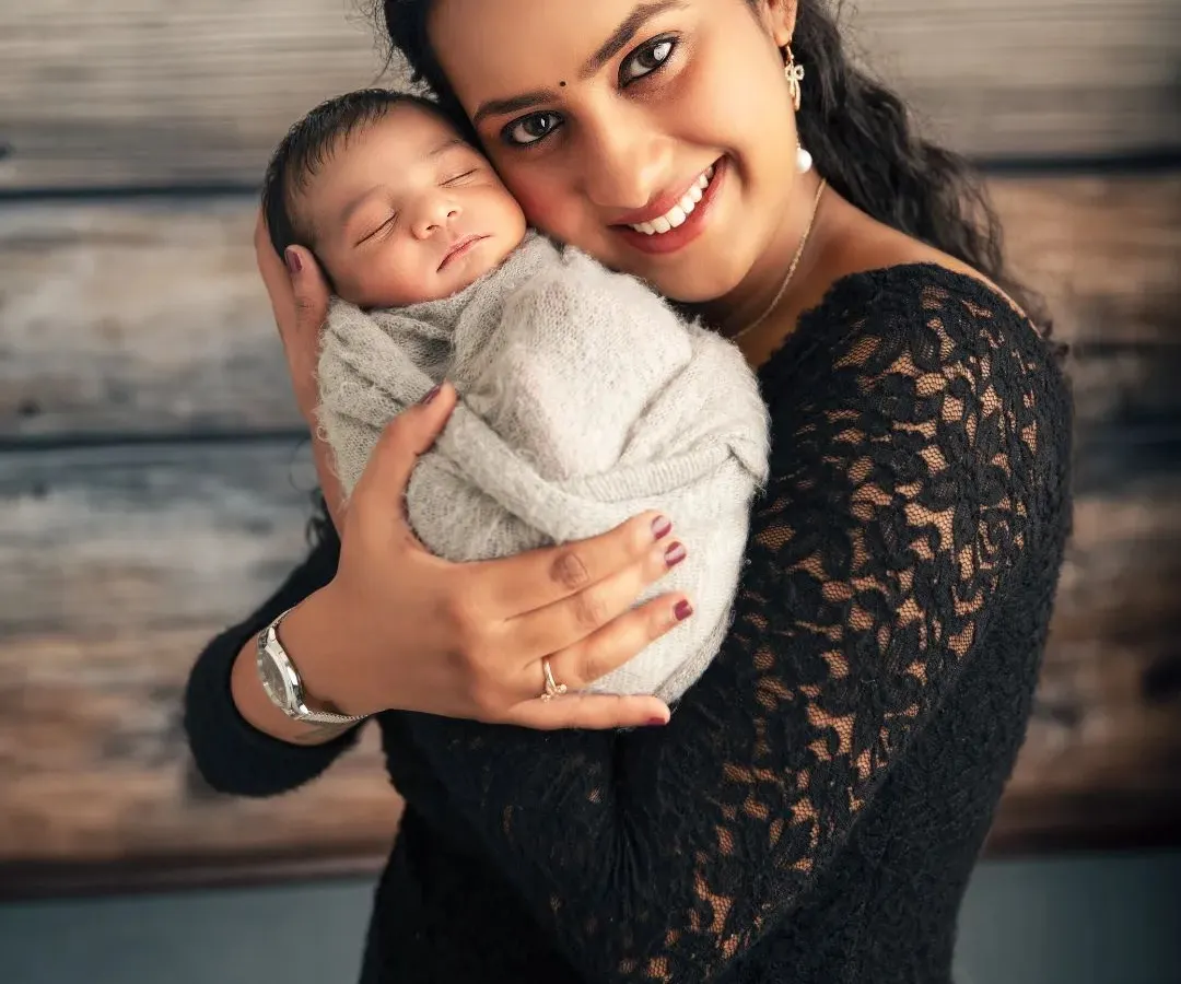 The purest love. In this simple, intimate portrait, a mother holds her newborn for the first time. I focus on capturing that immediate, powerful connection and the peaceful expression of a baby feeling safe and loved.